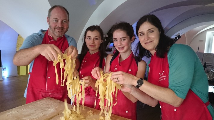 People cooking pasta together